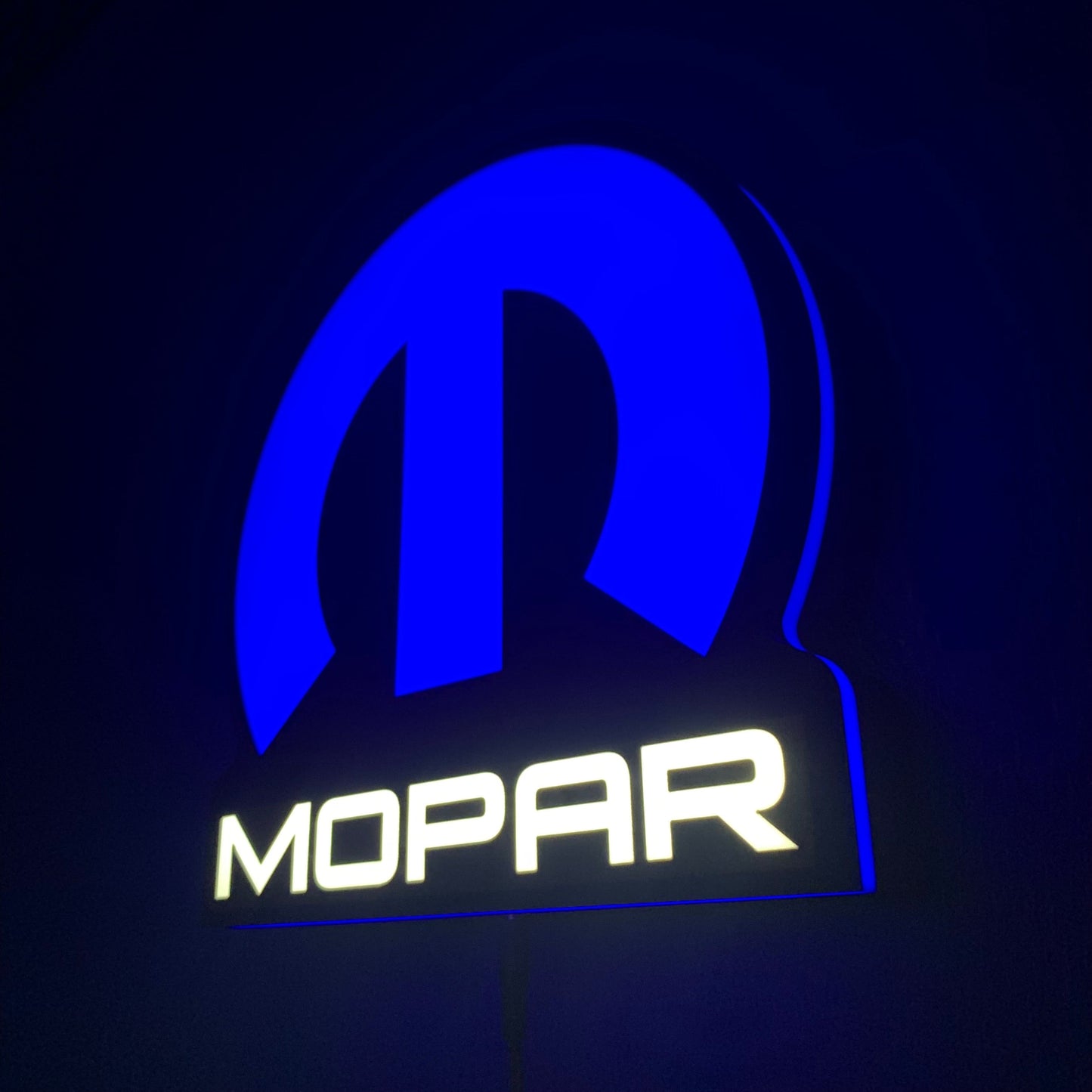 Mopar led indoor sing illuminated in blue and white on a dark background
