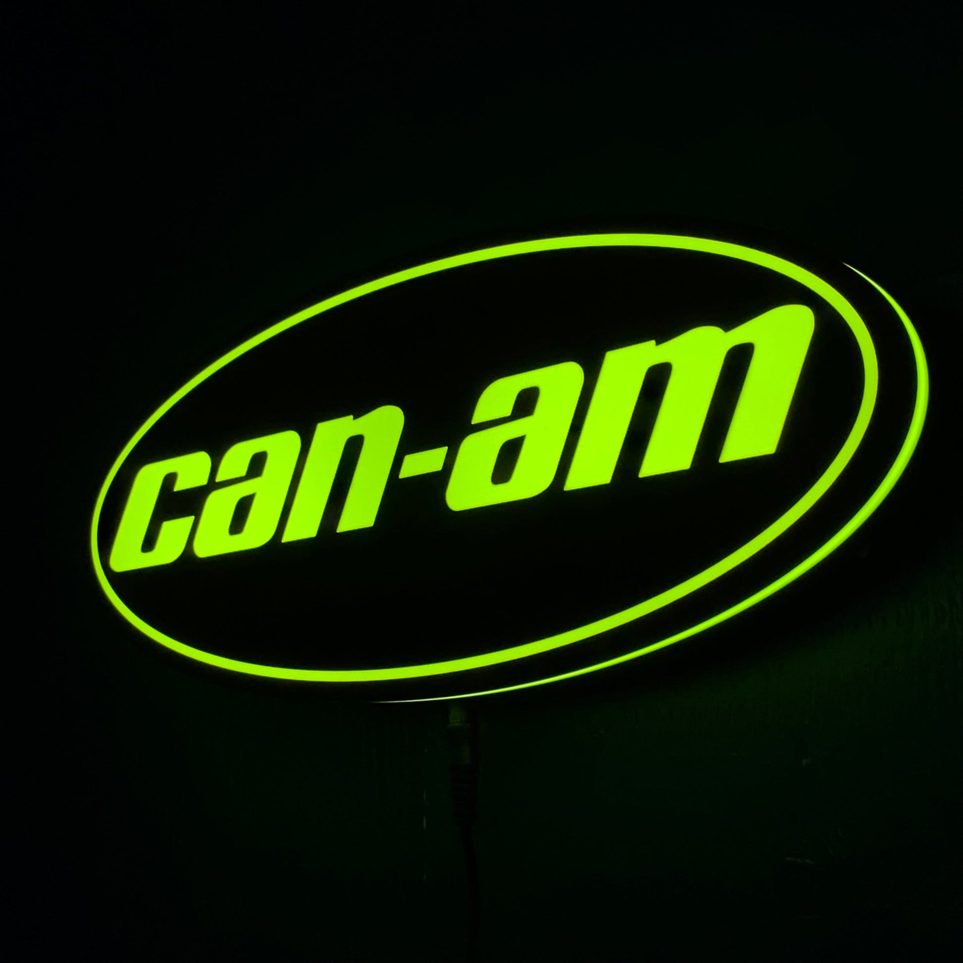 Can-Am led indoor sign lit up in green on a black background