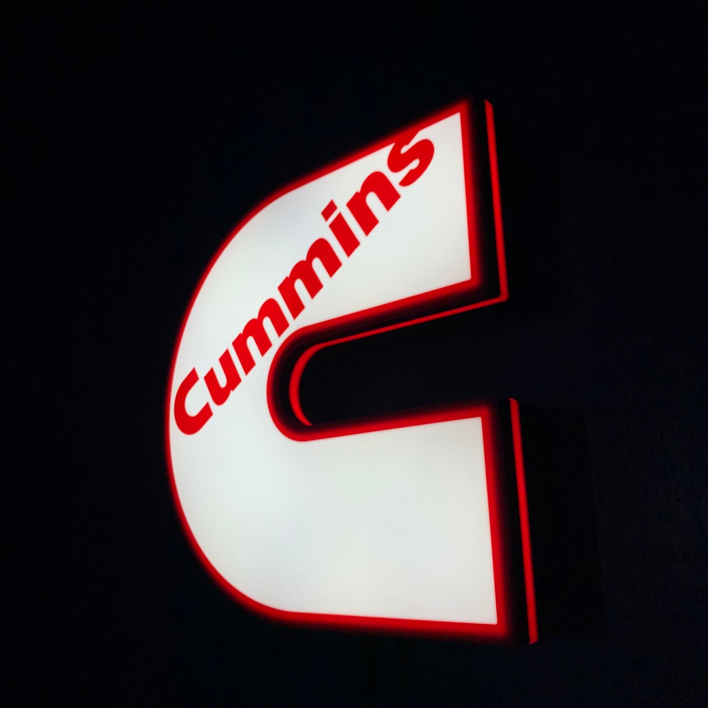 Cummins led indoor sign lit up on a black background