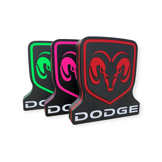 Three Dodge led indoor signs in different colors on a white background