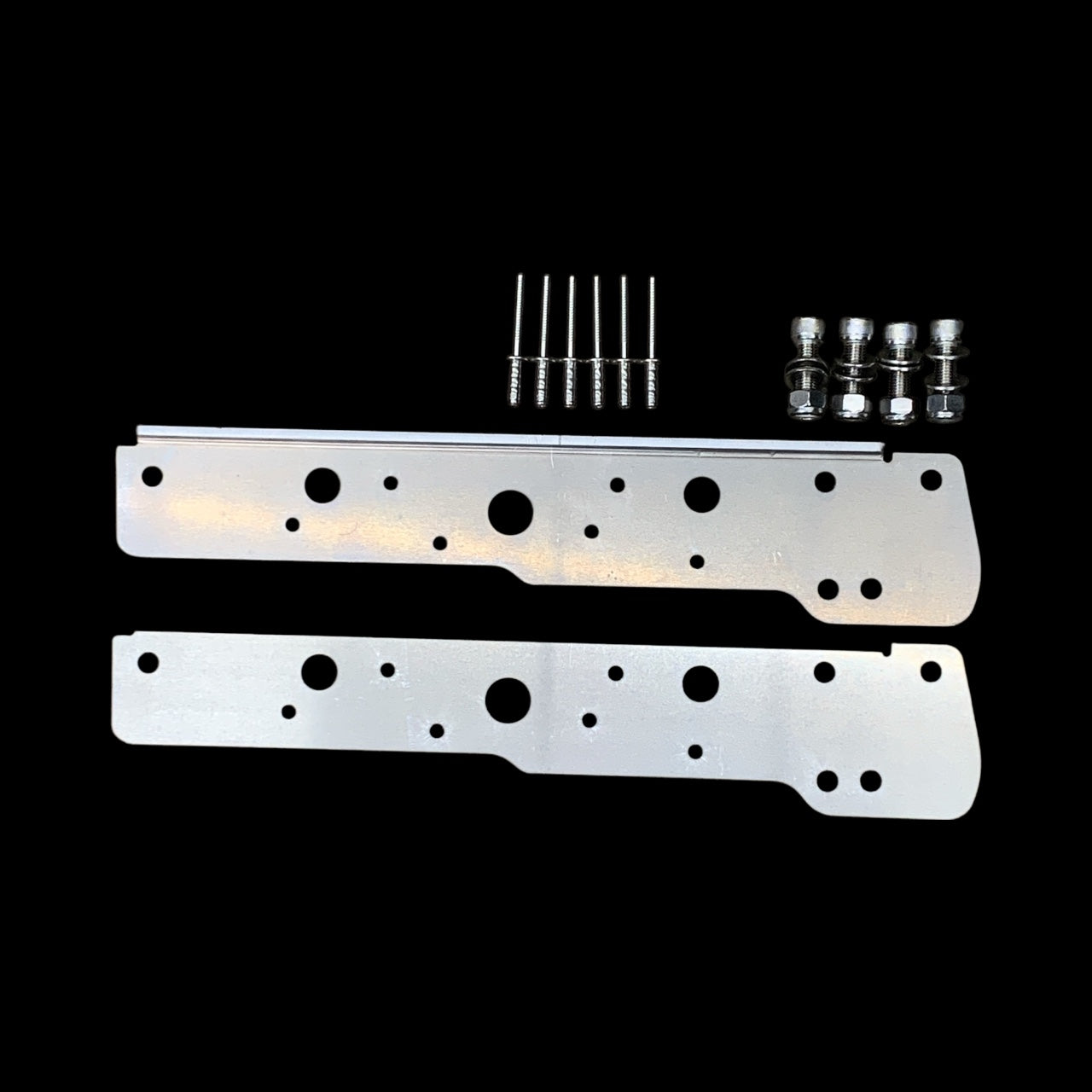 Two metal brackets with screws on a black background