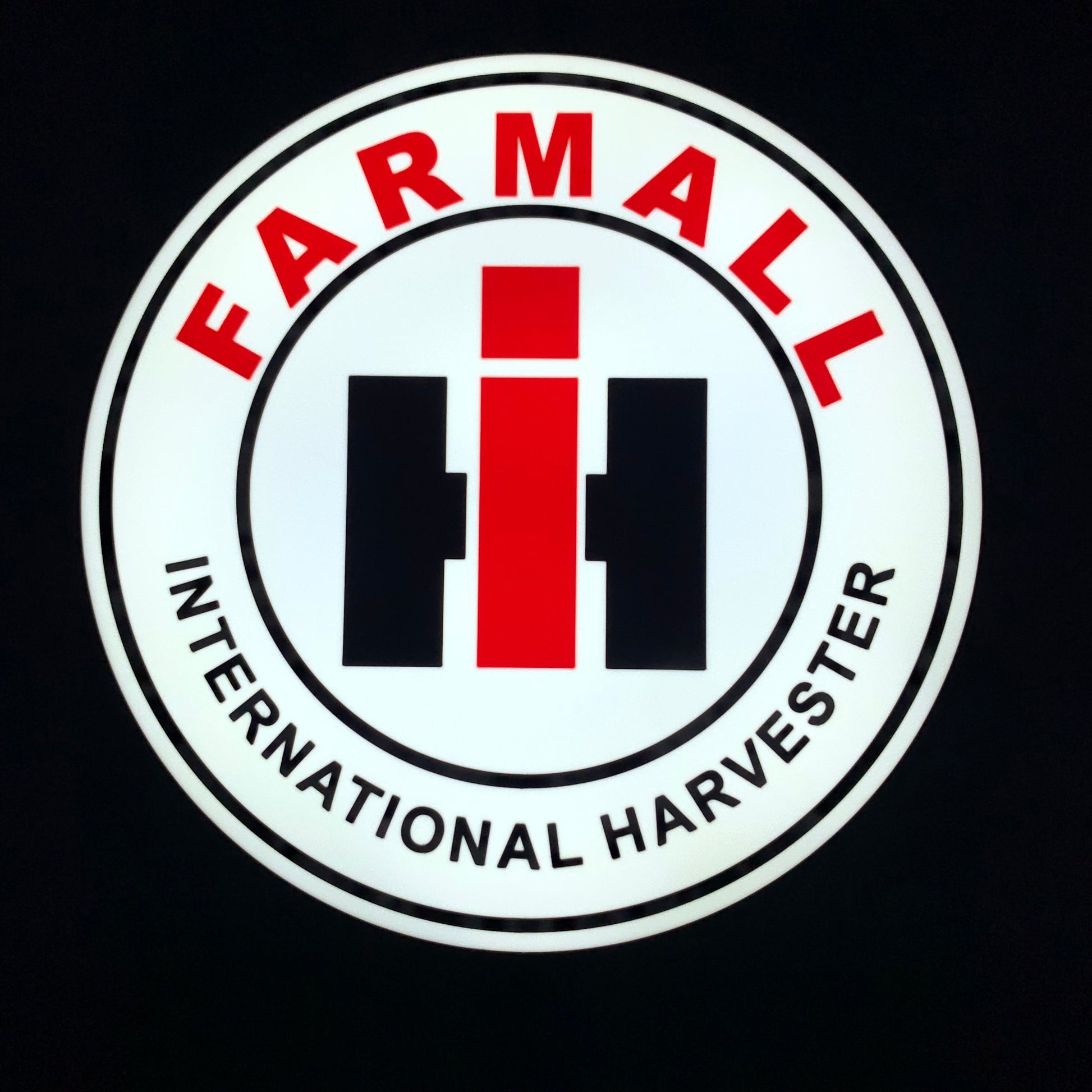 Farmall International Harvester led indoor sign lit up on a black background