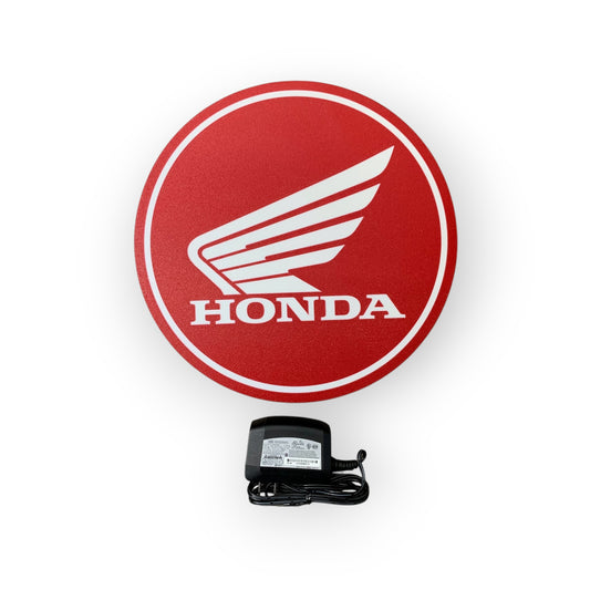 Red Honda led indoor sign with a power adapter on a white background