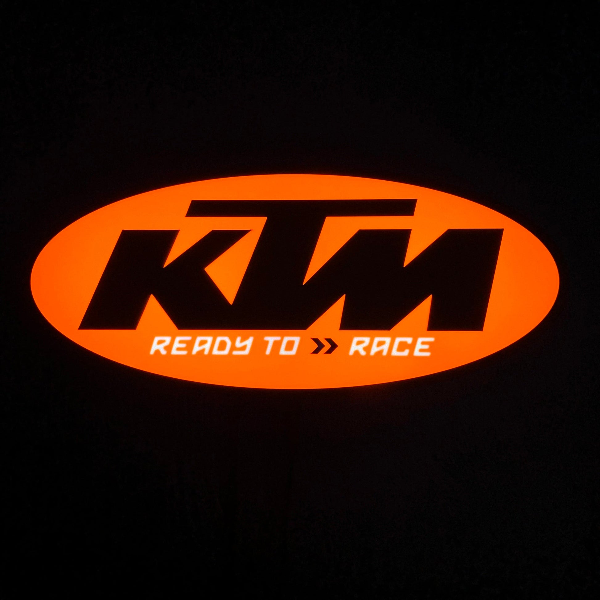 KTM led sign lit up with 'Ready to Race' text on a black background