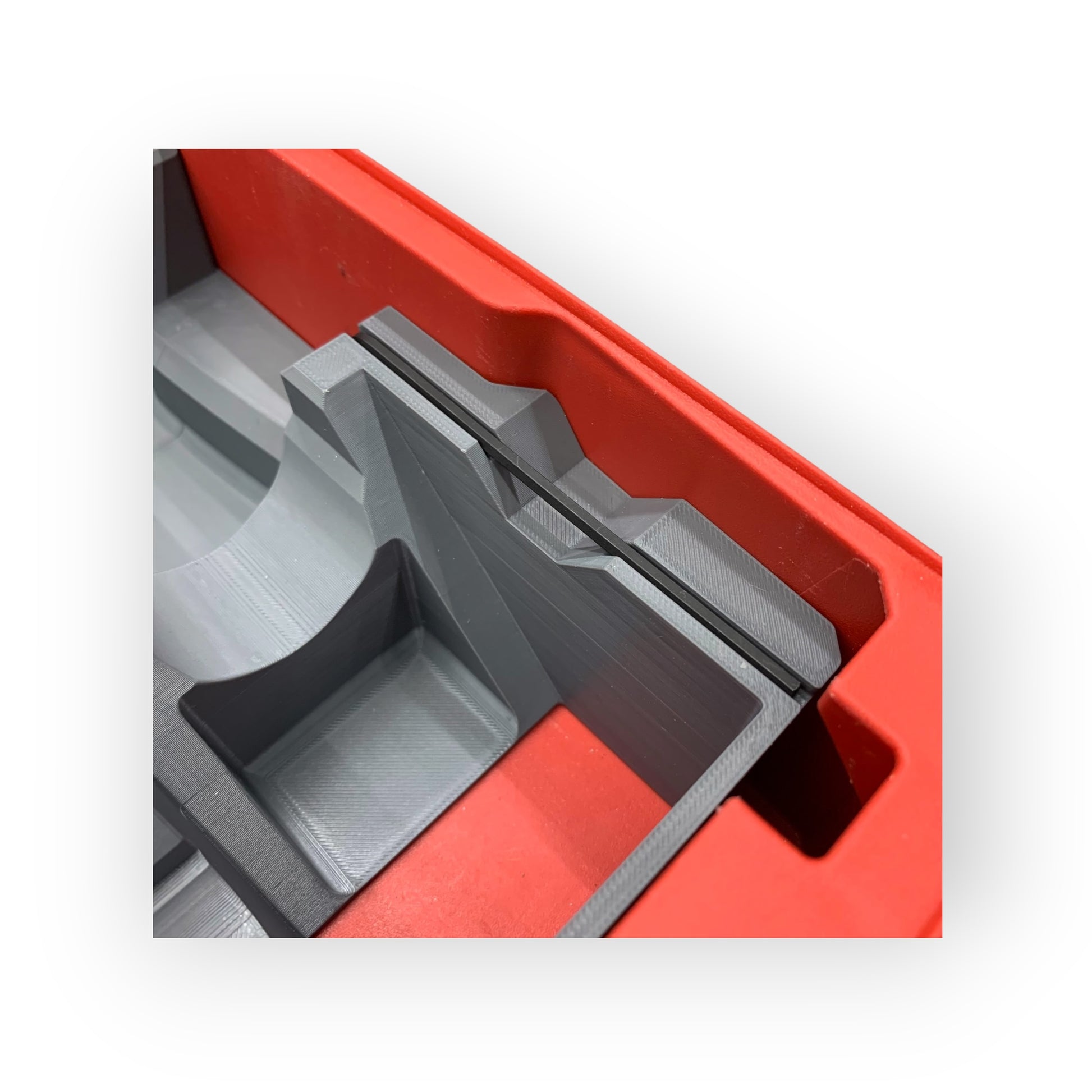 Close-up of a red and gray plastic component on a white background
