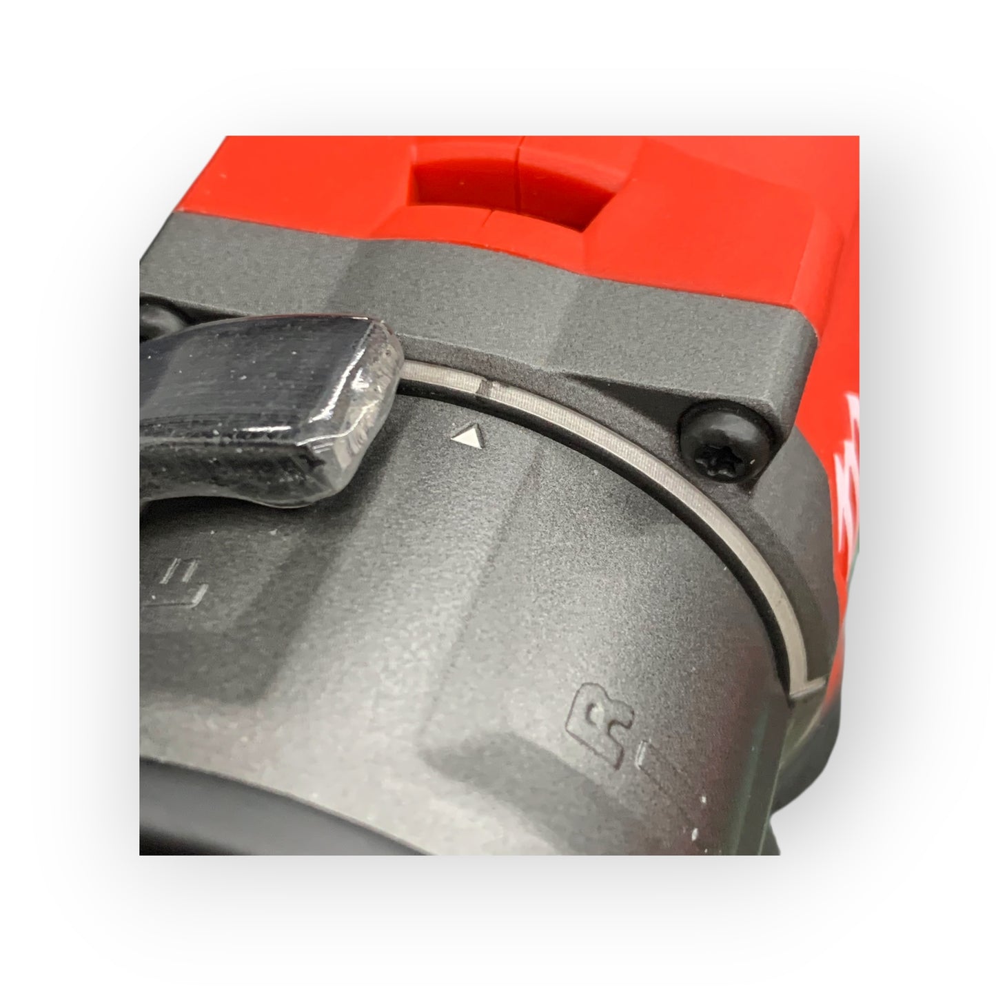 Close-up of a red and black tool with a visible brand logo on a white background