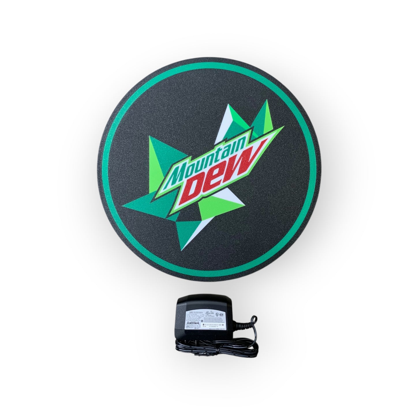 Round Mountain Dew led indoor sign with a power adapter on a white background
