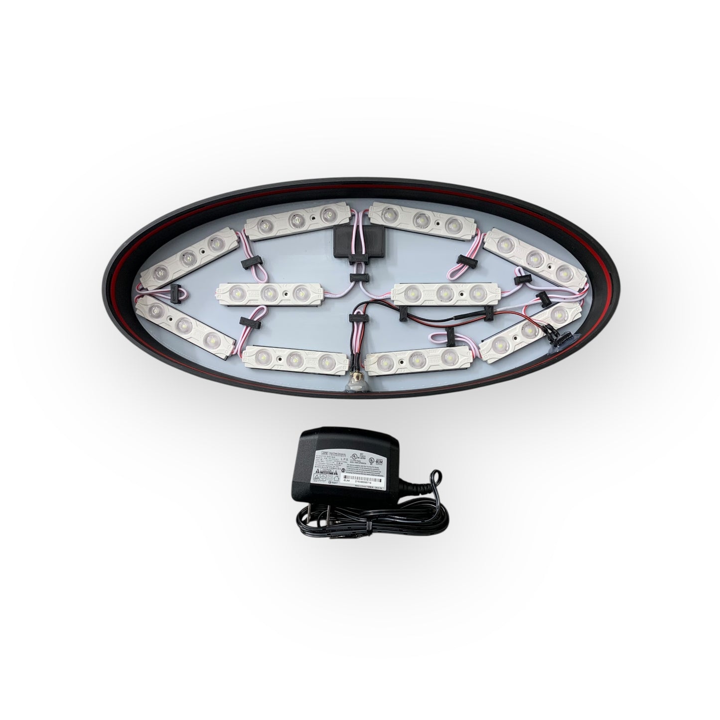 Inside of LED indoor sign showing 12V LED modules and a power adaptor