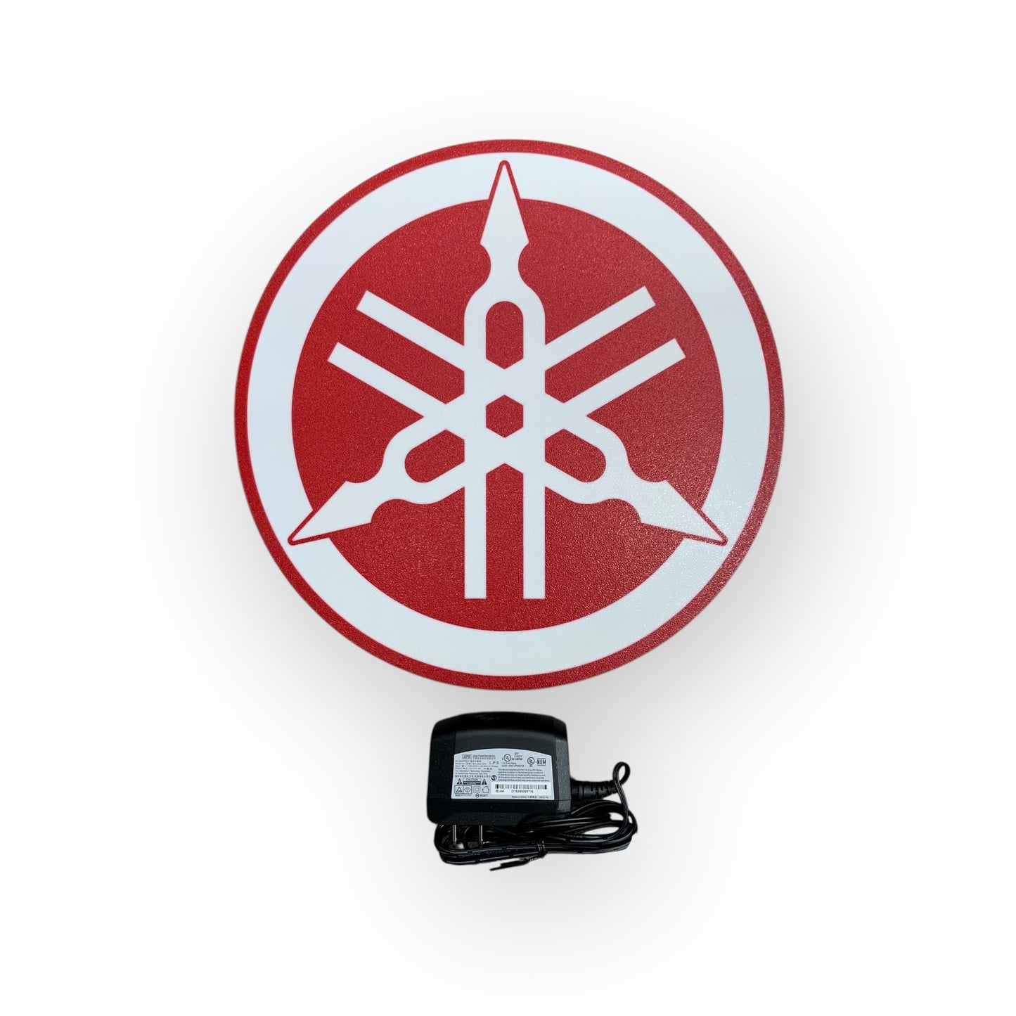 Yamaha logo on led indoor sign with a power adapter on a white background
